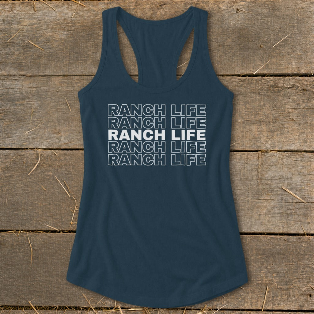 Dark blue racerback tank top with the repeated white text "RANCH LIFE" on a wooden background.