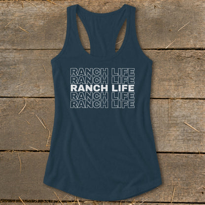 Dark blue racerback tank top with the repeated white text "RANCH LIFE" on a wooden background.