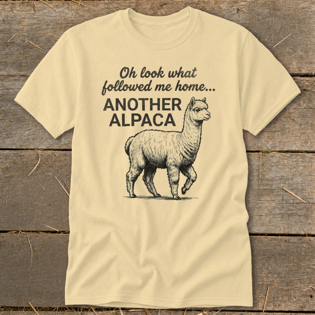 Light yellow t-shirt with text "Oh look what followed me home... ANOTHER ALPACA" and an alpaca drawing.