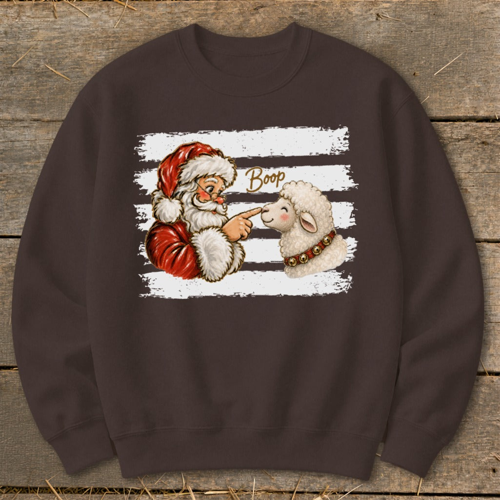 Santa booping a sheep with the word "Boop" on a brown sweatshirt.