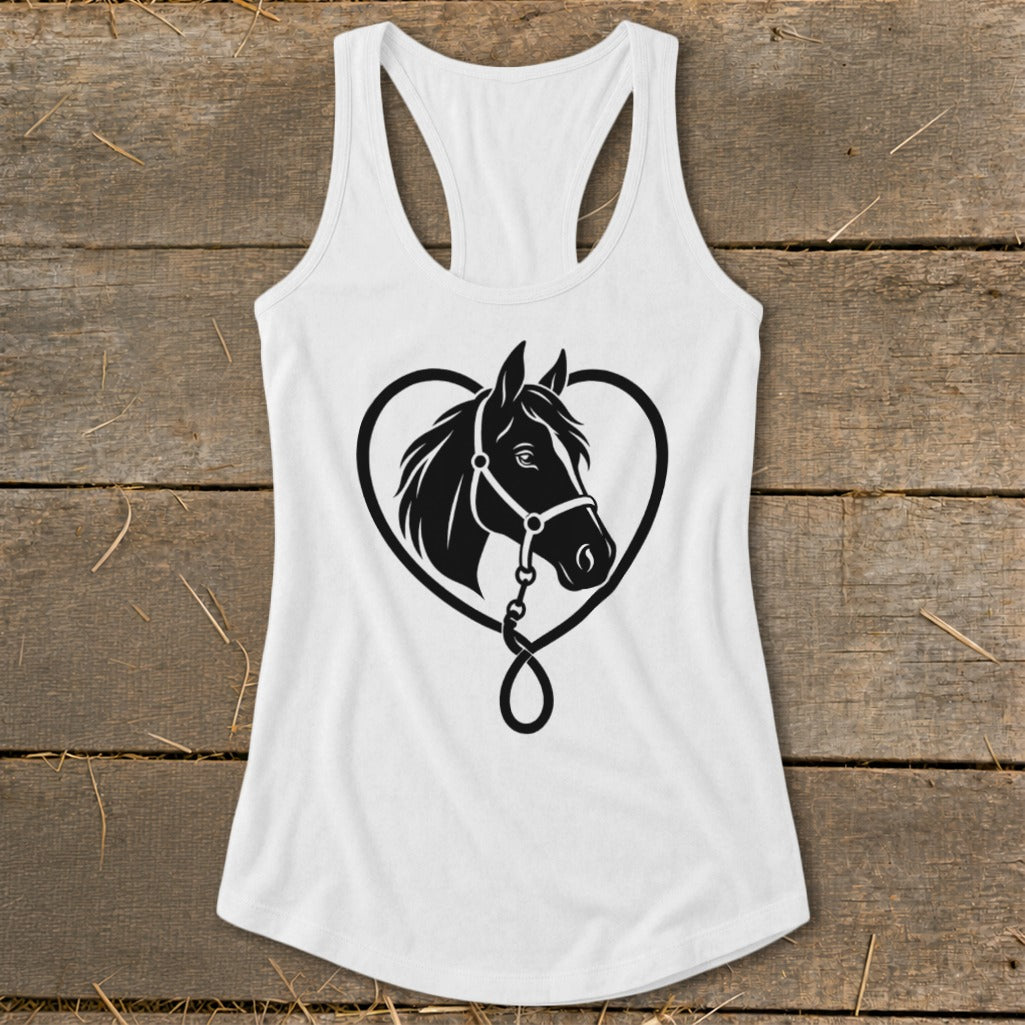 White women's racerback tank top featuring a black horse head silhouette inside a heart design, displayed flat on a rustic wooden background.