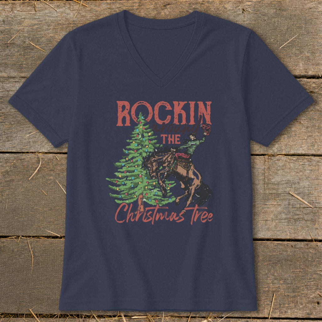 Navy v-neck t-shirt with a rodeo rider and Christmas tree graphic that reads "Rockin The Christmas Tree".