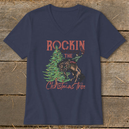 Navy v-neck t-shirt with a rodeo rider and Christmas tree graphic that reads "Rockin The Christmas Tree".