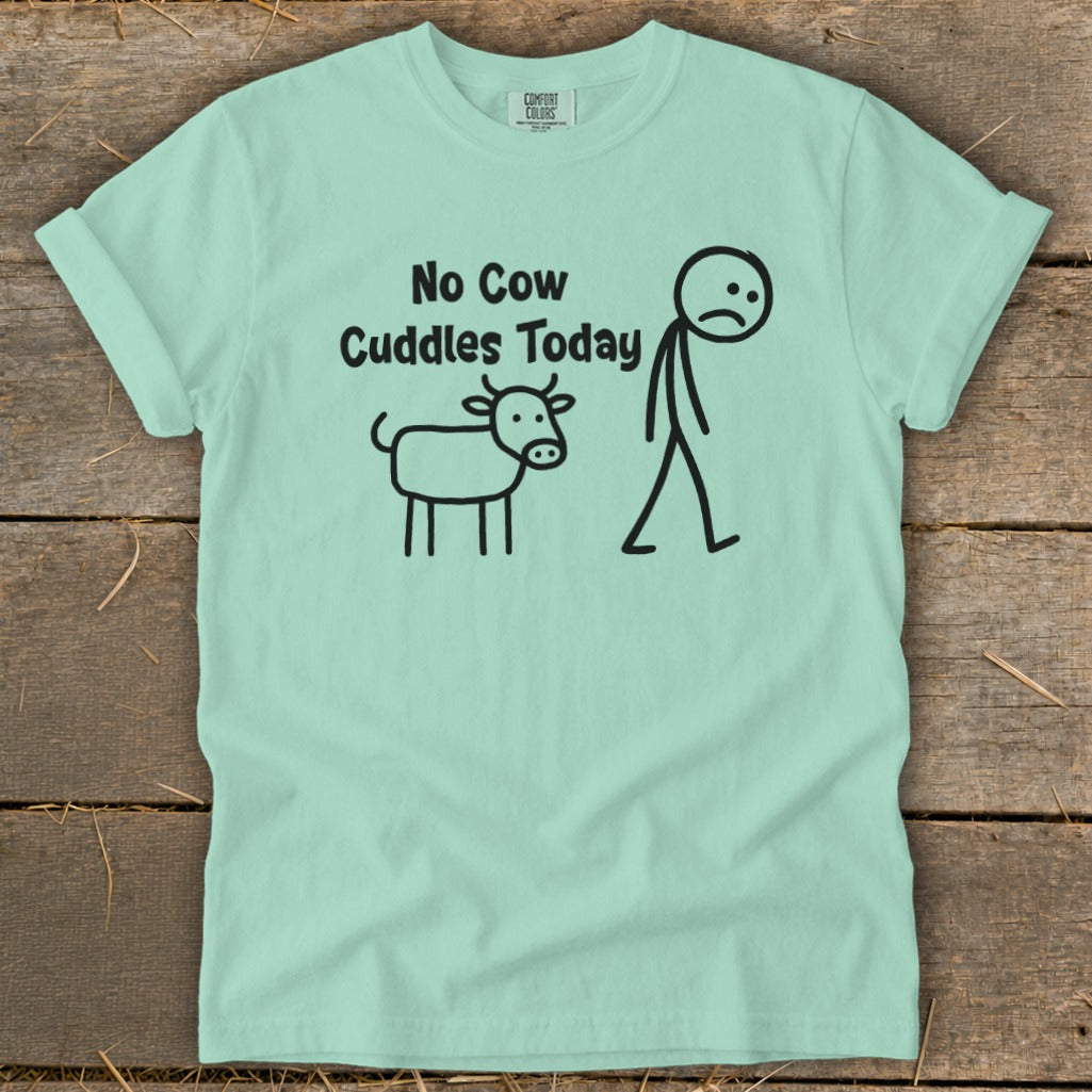 Light green t-shirt with "No Cow Cuddles Today" and stick figures of a cow and person.