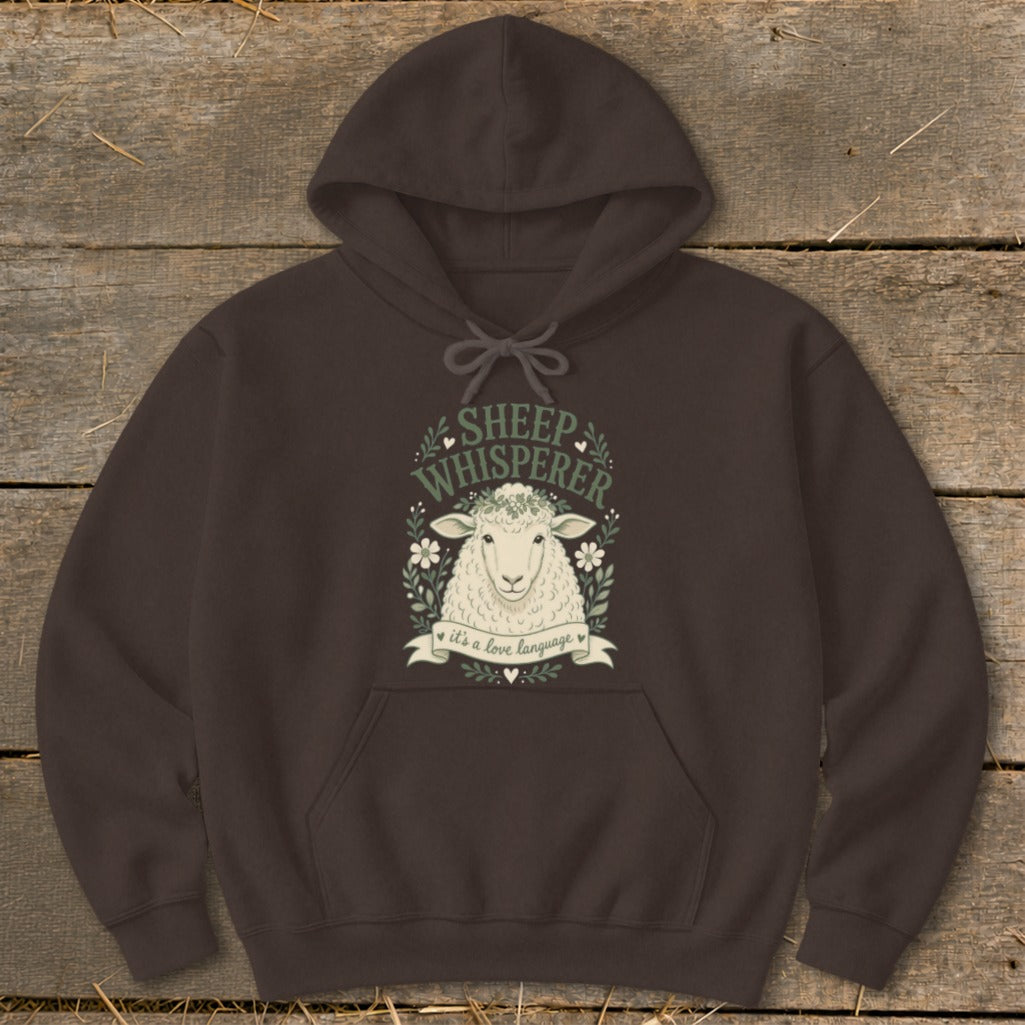 Dark brown hoodie with a sheep illustration and "Sheep Whisperer" text.