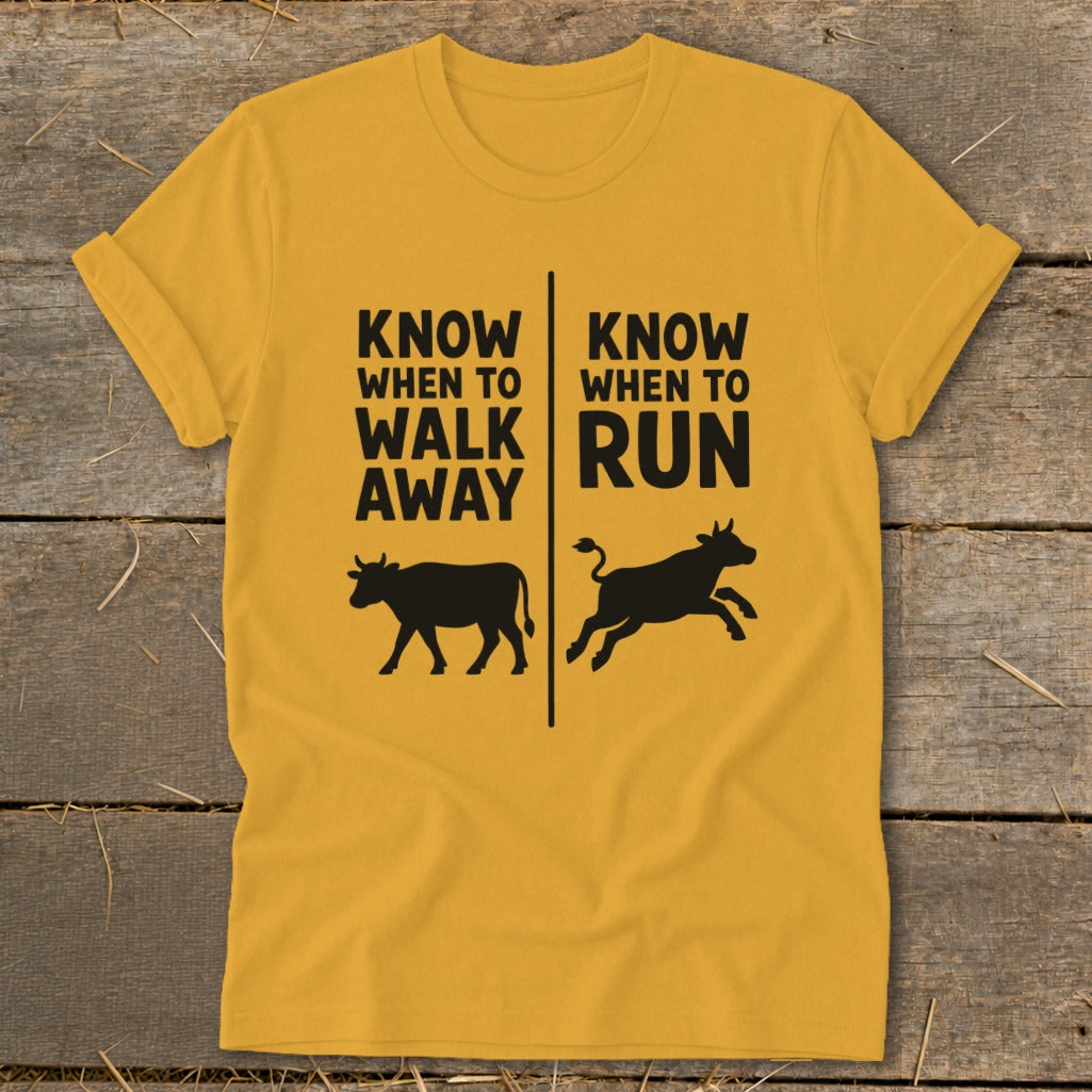 Yellow t-shirt with text "Know When to Walk Away" and "Know When to Run" above cows.