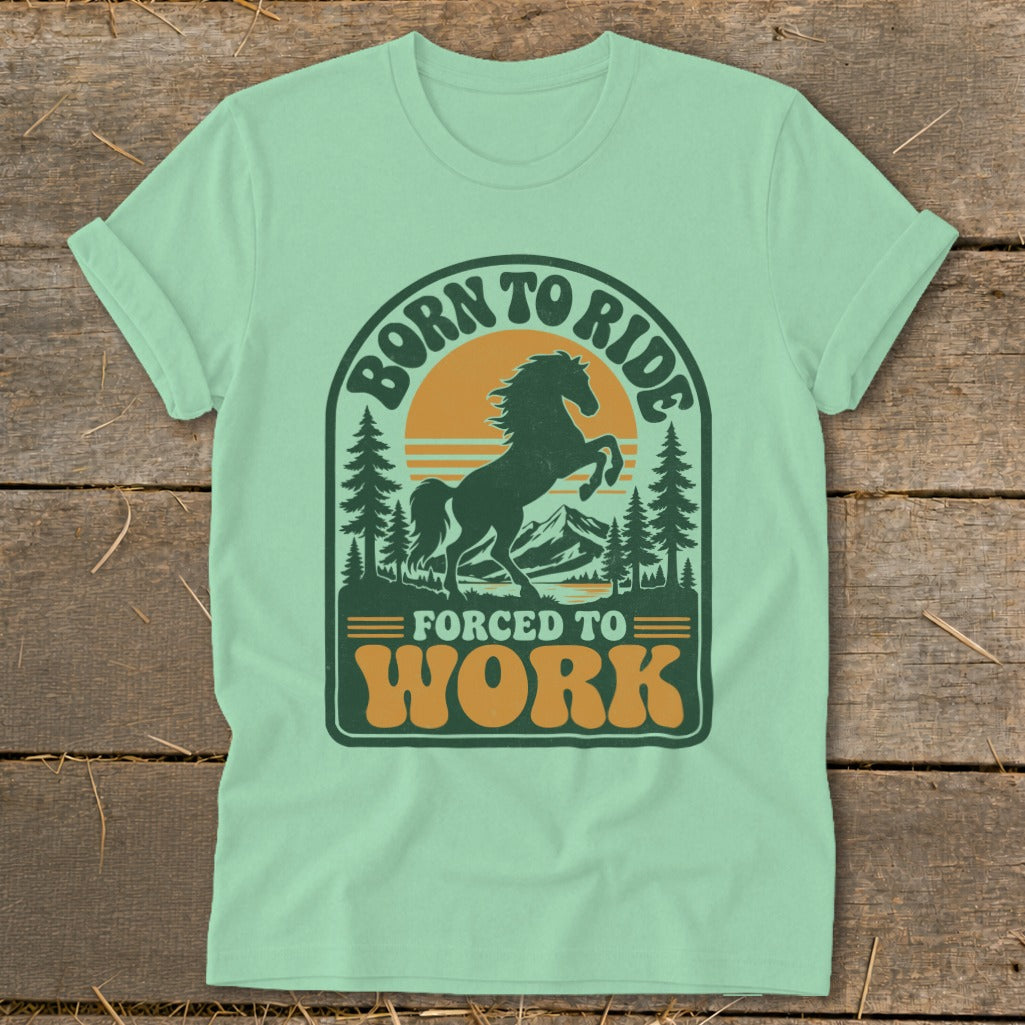 Light green t-shirt with "Born to Ride, Forced to Work" graphic featuring a horse and mountains.