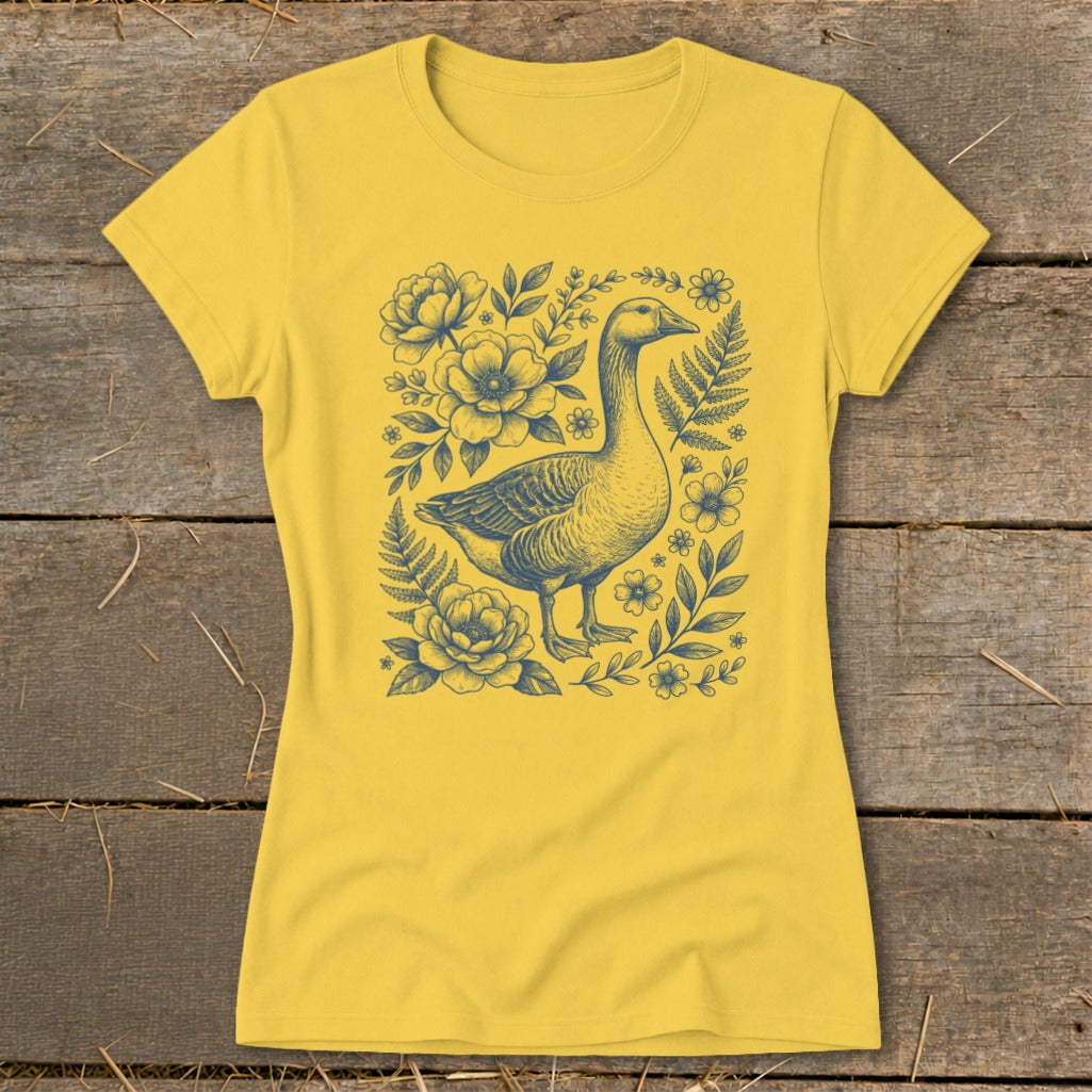 Yellow t-shirt with blue goose and floral illustration in the center.