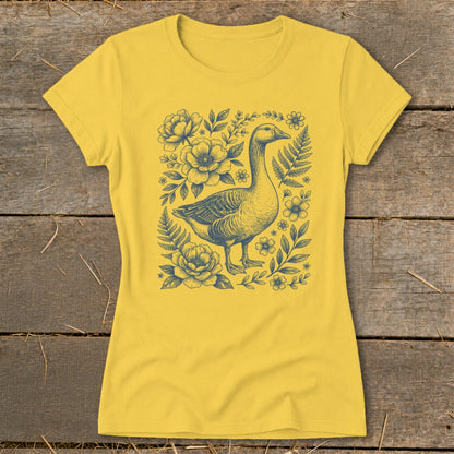 Yellow t-shirt with blue goose and floral illustration in the center.