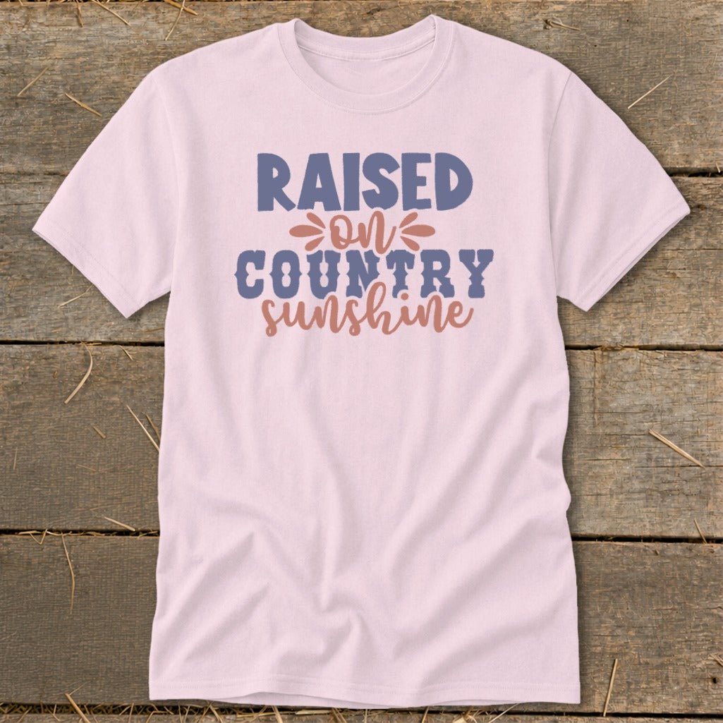 Light pink t-shirt with "Raised on Country Sunshine" graphic.