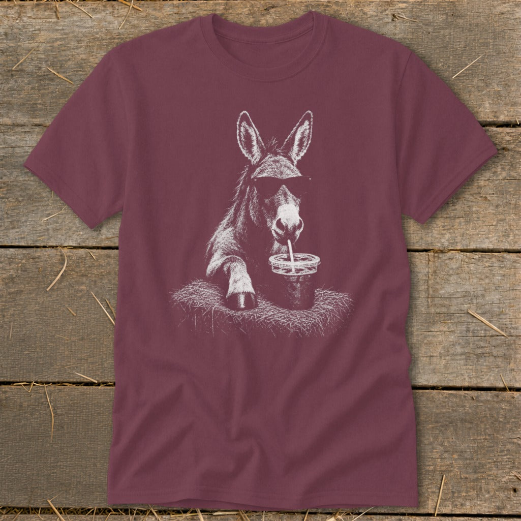 Donkey wearing sunglasses drinks from a cup with a straw on a t-shirt.