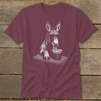 Donkey wearing sunglasses drinks from a cup with a straw on a t-shirt.