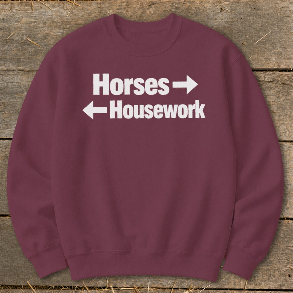 Maroon crewneck sweatshirt with white text reading Horses pointing right and Housework pointing left.