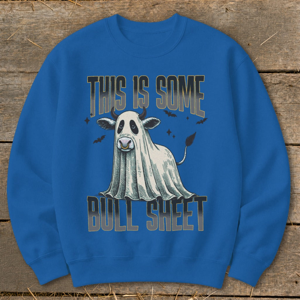 Cow dressed as a ghost on a blue sweatshirt with text "THIS IS SOME BULL SHEET".