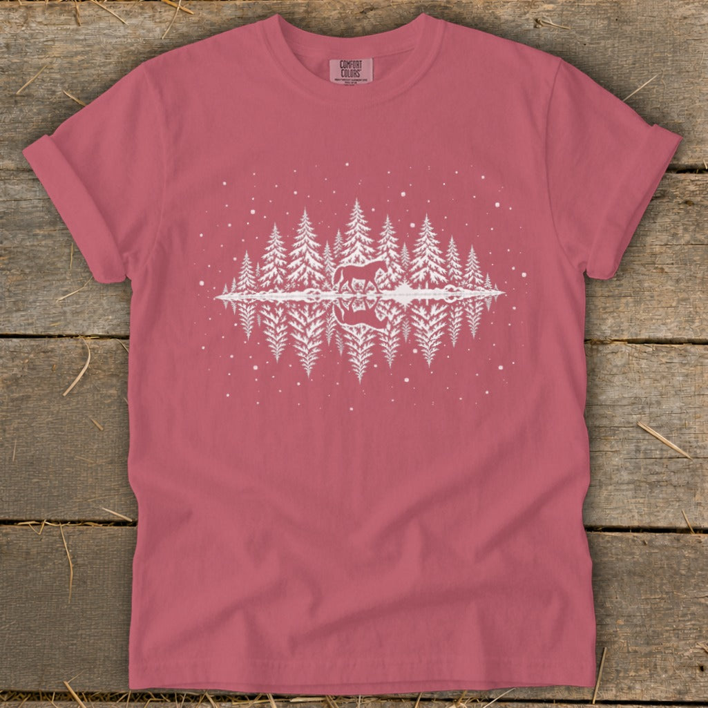 Pink t-shirt with white graphic of snowy pine trees and a reflected horse.
