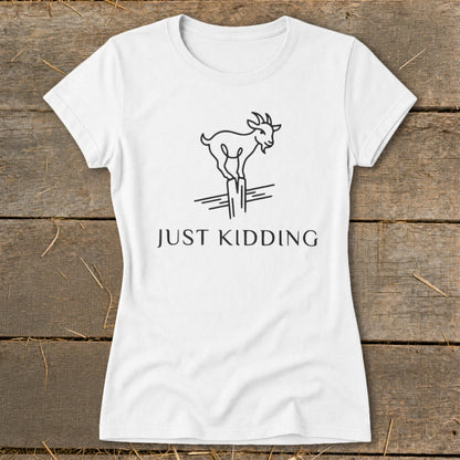 White t-shirt with a black line drawing of a goat standing on posts and the text "JUST KIDDING".