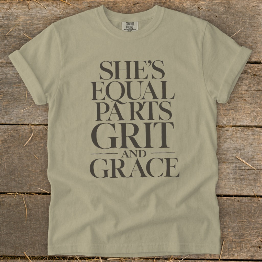 Light tan t-shirt with text "She's Equal Parts Grit and Grace."
