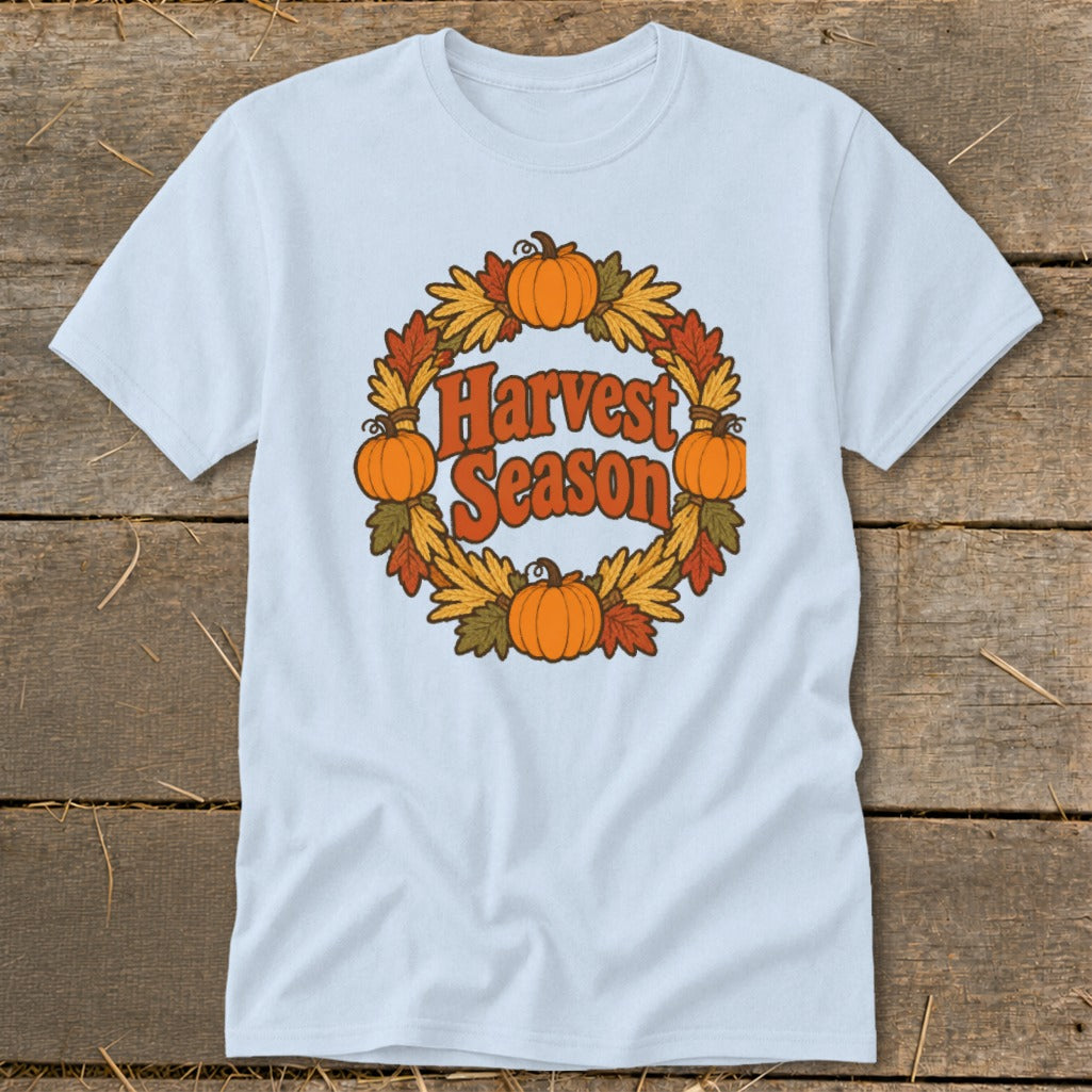 Light blue t-shirt with a "Harvest Season" graphic in a wreath of pumpkins and fall leaves.