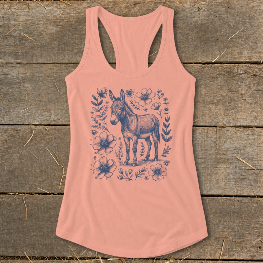 Peach tank top with a blue donkey surrounded by flowers and leaves.