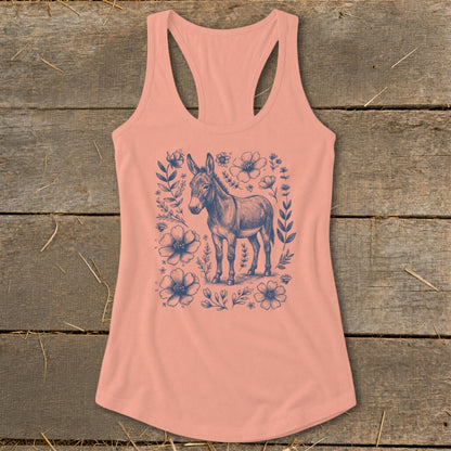 Peach tank top with a blue donkey surrounded by flowers and leaves.