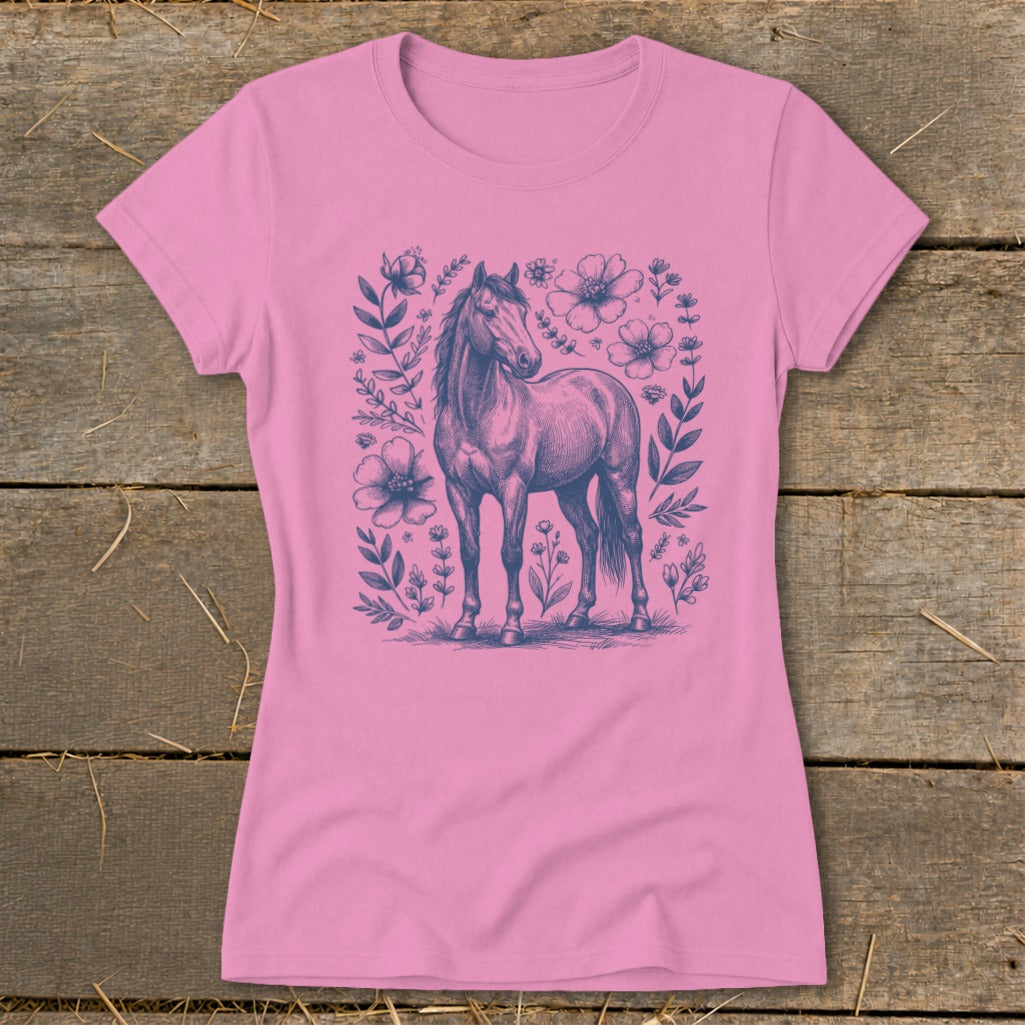 Pink t-shirt with a detailed drawing of a horse surrounded by flowers and leaves.