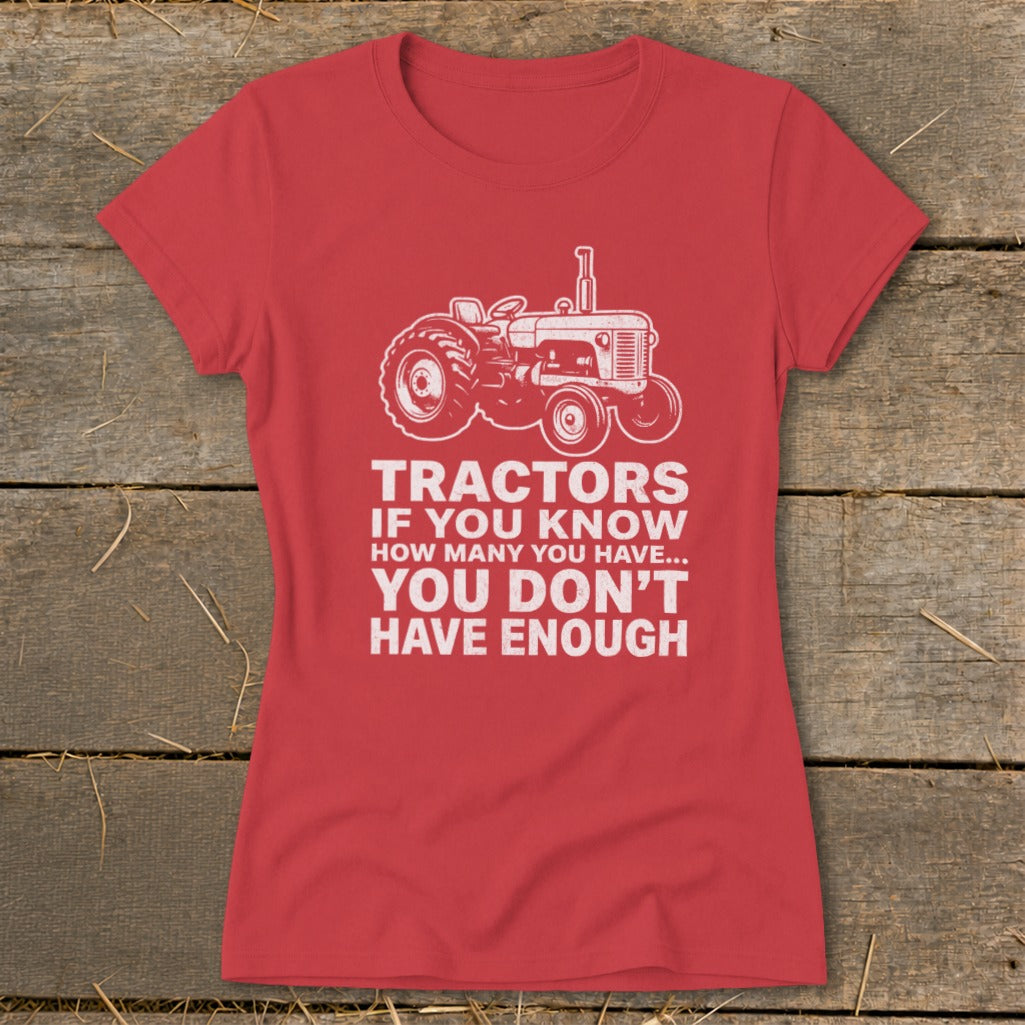 Red t-shirt with white graphic of a tractor and text: "TRACTORS IF YOU KNOW HOW MANY YOU HAVE... YOU DON'T HAVE ENOUGH"