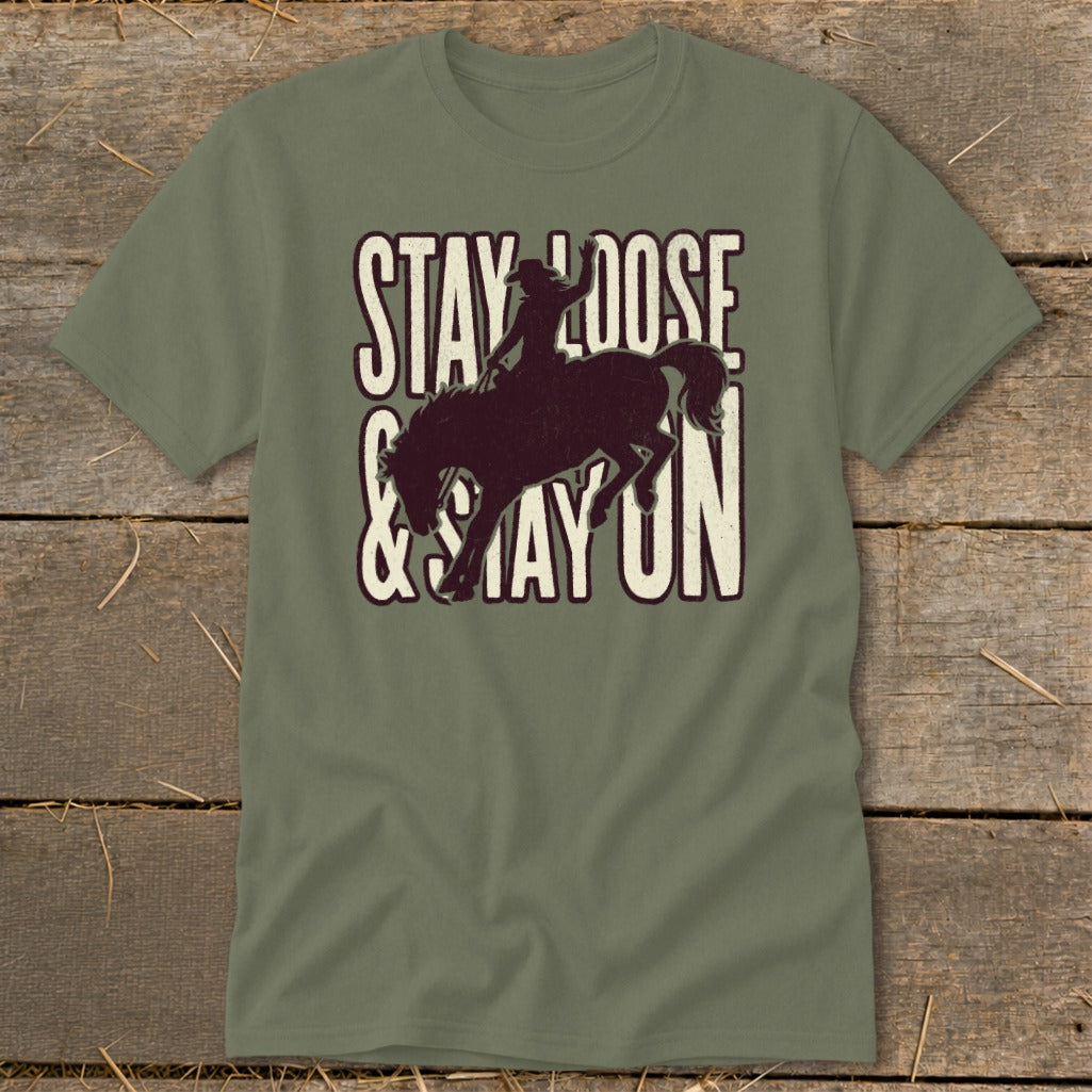 Green t-shirt with "STAY LOOSE & STAY ON" text and bucking bronco graphic.