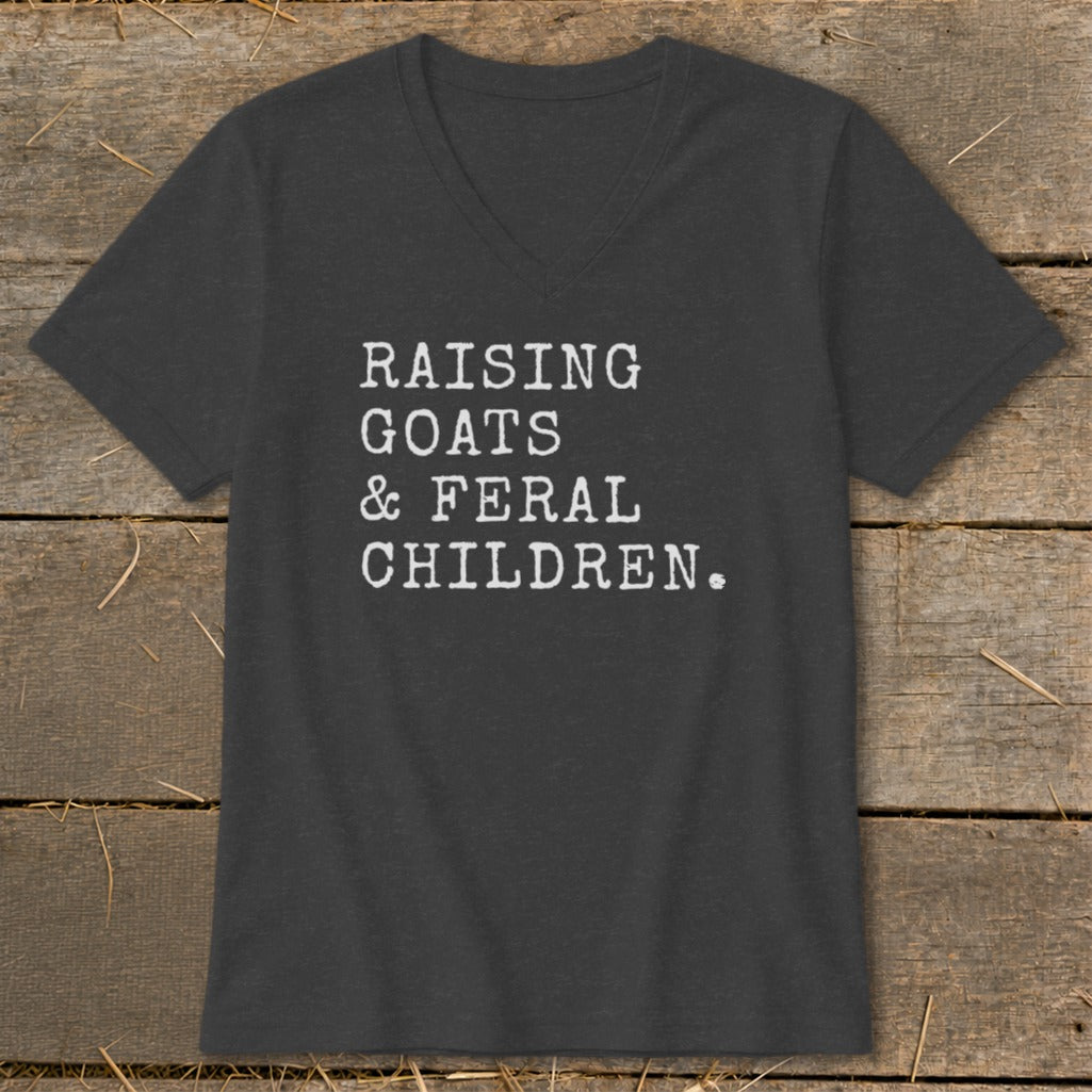 Dark grey v-neck t-shirt with white text "RAISING GOATS & FERAL CHILDREN."