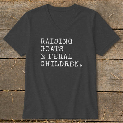 Dark grey v-neck t-shirt with white text "RAISING GOATS & FERAL CHILDREN."