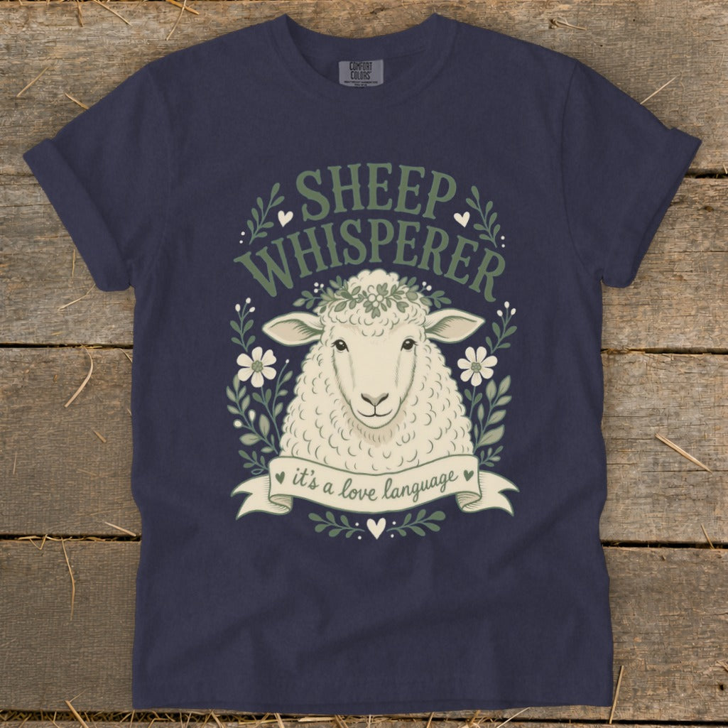 Navy t-shirt with a sheep graphic and text "SHEEP WHISPERER it's a love language".