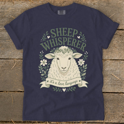 Navy t-shirt with a sheep graphic and text "SHEEP WHISPERER it's a love language".