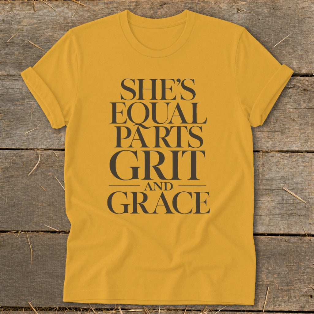 Yellow t-shirt with text "SHE'S EQUAL PARTS GRIT AND GRACE".