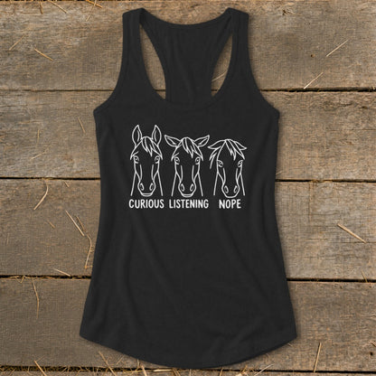 A black women's racerback tank top featuring a white graphic of three horse heads with the captions "Curious," "Listening," and "Nope."