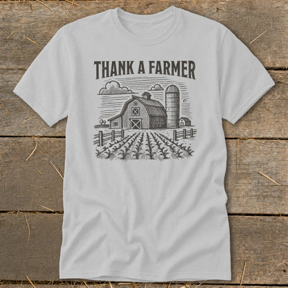 Light gray t-shirt with "THANK A FARMER" text and barn, silo, and field graphic.
