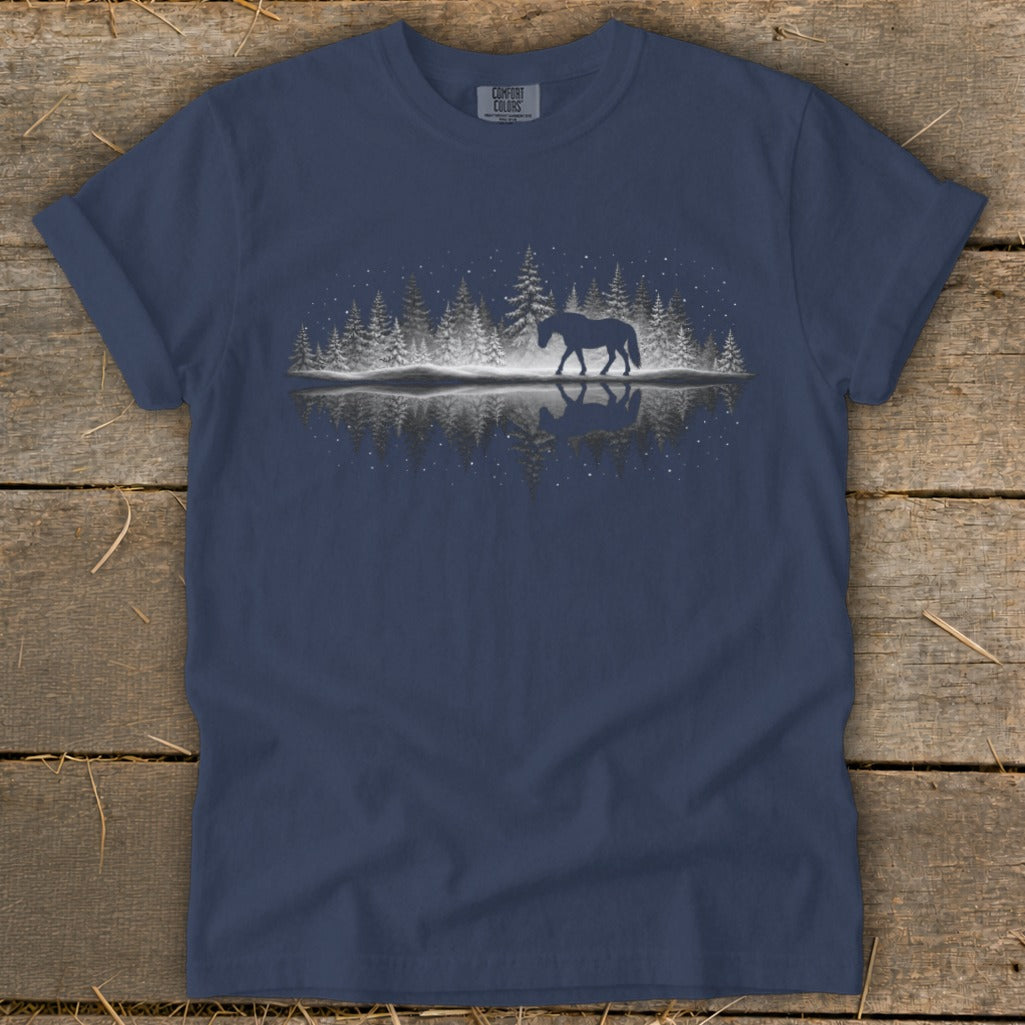 Dark blue t-shirt with a silhouette of a horse walking in a snowy forest reflected in water.