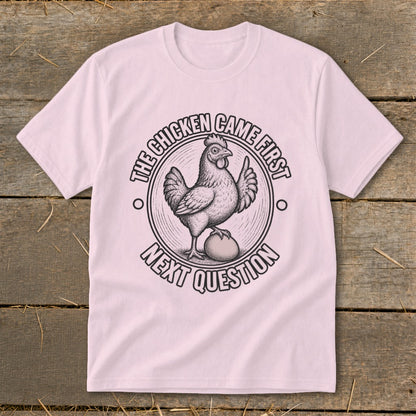 T-shirt with a chicken and egg graphic that reads "The chicken came first. Next question."