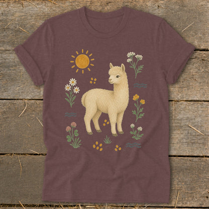T-shirt with cream alpaca surrounded by wildflowers and a sun graphic.