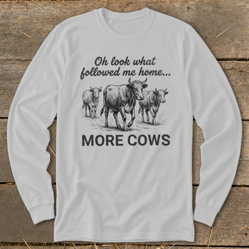 Long sleeve shirt with sketch of cows and text "Oh look what followed me home... MORE COWS".