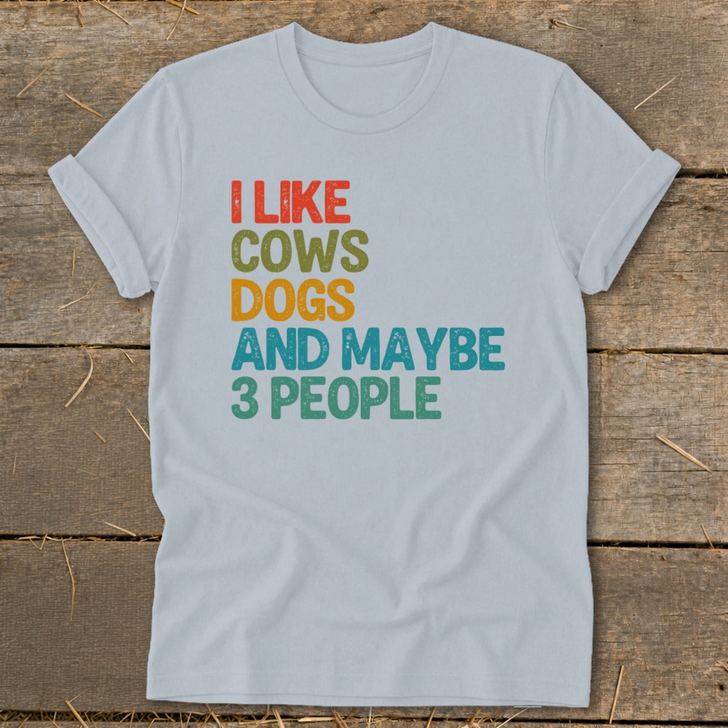 Light blue t-shirt with text "I like cows dogs and maybe 3 people".