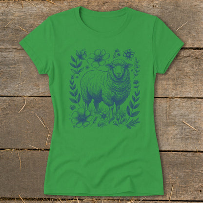 Green t-shirt with a blue line drawing of a sheep surrounded by flowers and leaves.