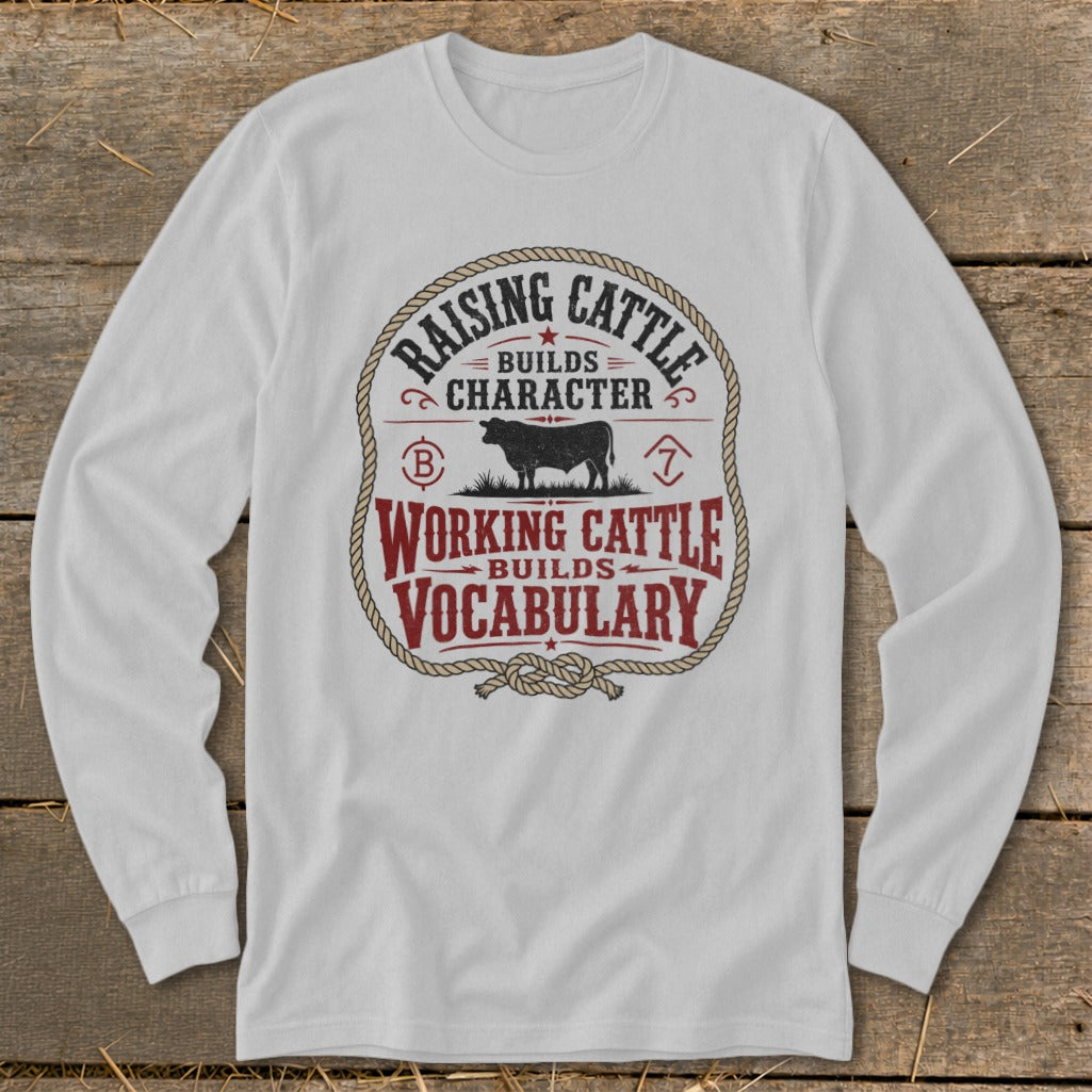 White long-sleeve shirt with "Raising Cattle Builds Character, Working Cattle Builds Vocabulary" graphic.