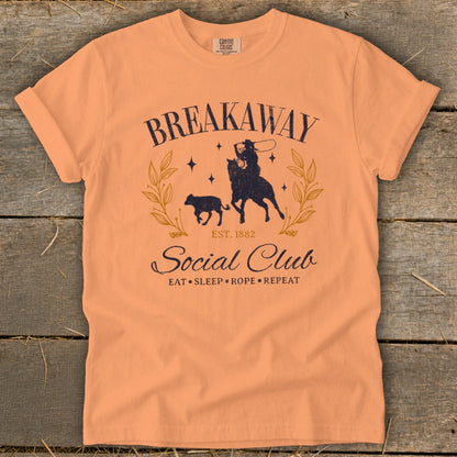 Peach t-shirt with "Breakaway Social Club" and a rodeo graphic.