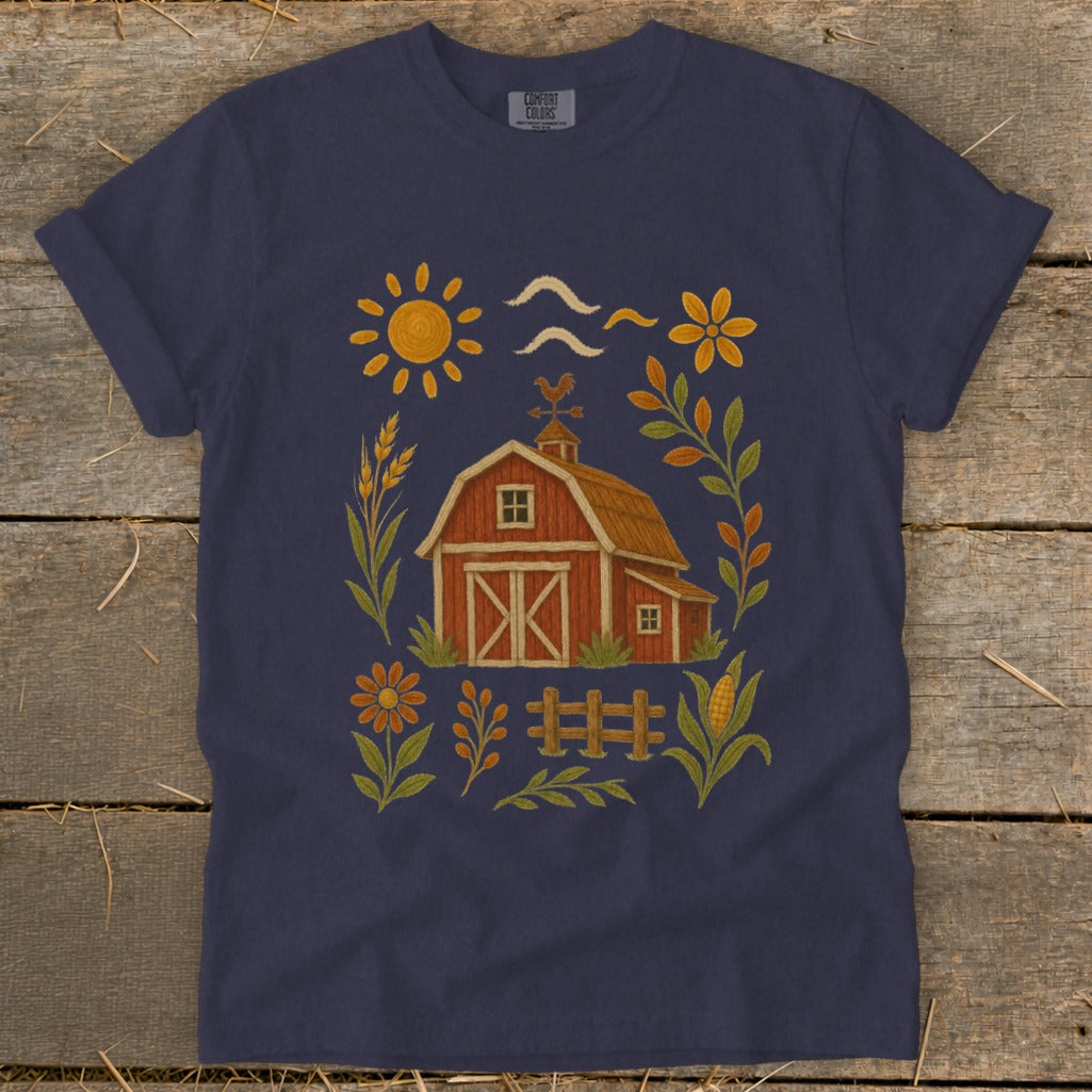 Navy t-shirt with a rustic barn, sun, flowers, and farm elements.
