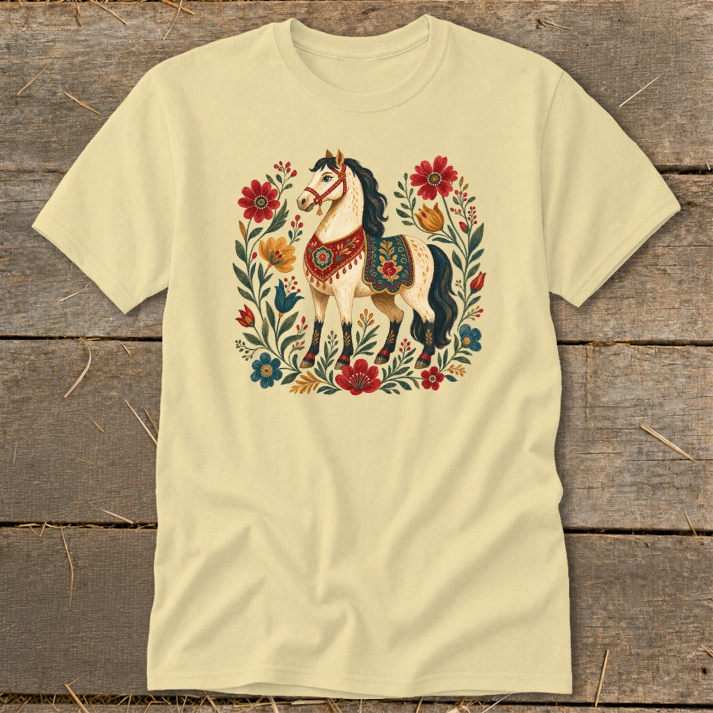 Light yellow t-shirt with a stylized horse surrounded by flowers and foliage.