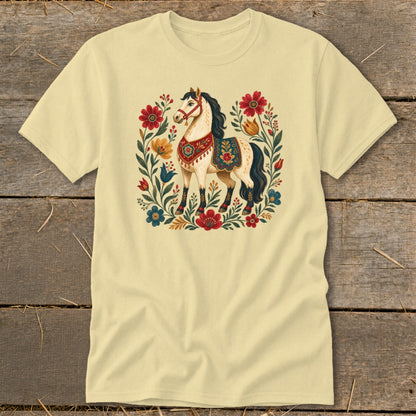 Light yellow t-shirt with a stylized horse surrounded by flowers and foliage.