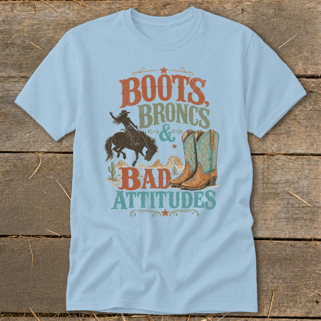 Light blue t-shirt with "Boots, Broncs & Bad Attitudes" graphic and cowboy boots.