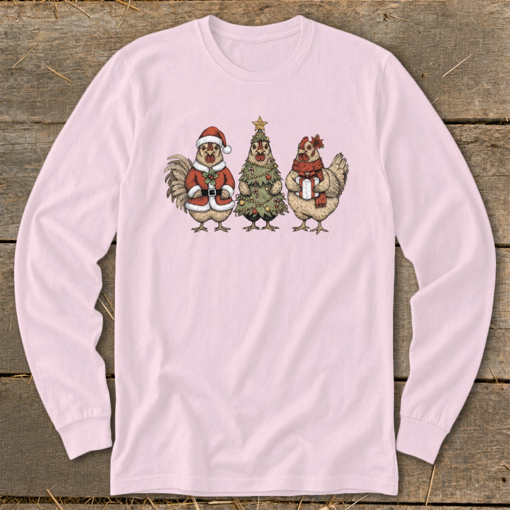 Long sleeve pink shirt with cartoon chickens in Christmas attire, including Santa, a tree, and a gift.
