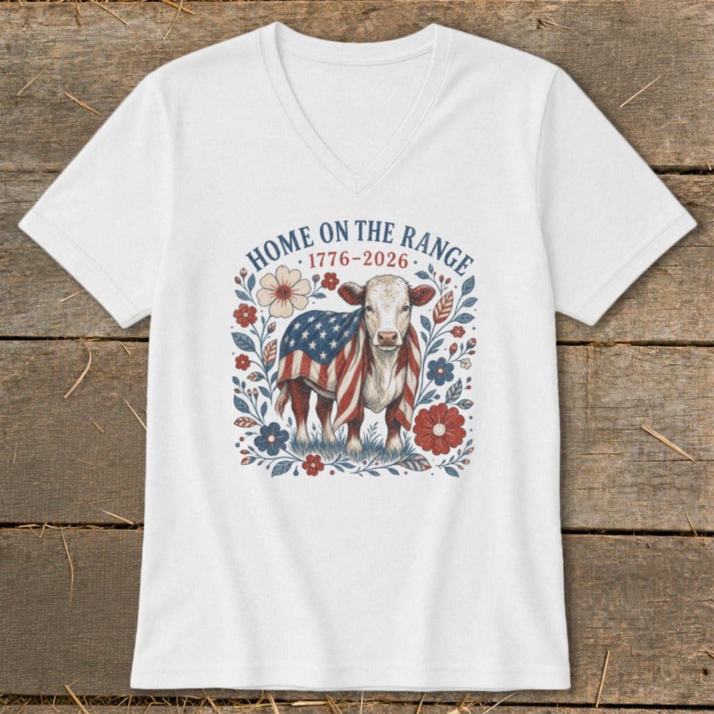 White t-shirt with a cow wrapped in an American flag, surrounded by flowers.
