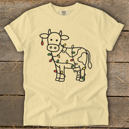 Yellow t-shirt with a cow outline decorated with colorful Christmas lights.