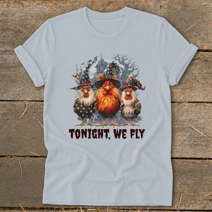 Three chickens in witch hats stand before a spooky house. "TONIGHT, WE FLY" is written below.